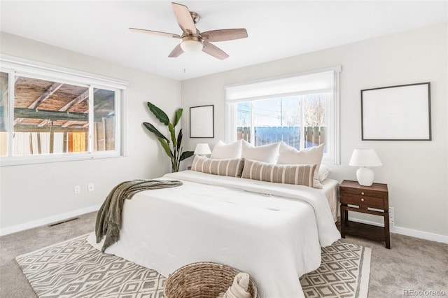 bedroom with ceiling fan and light colored carpet