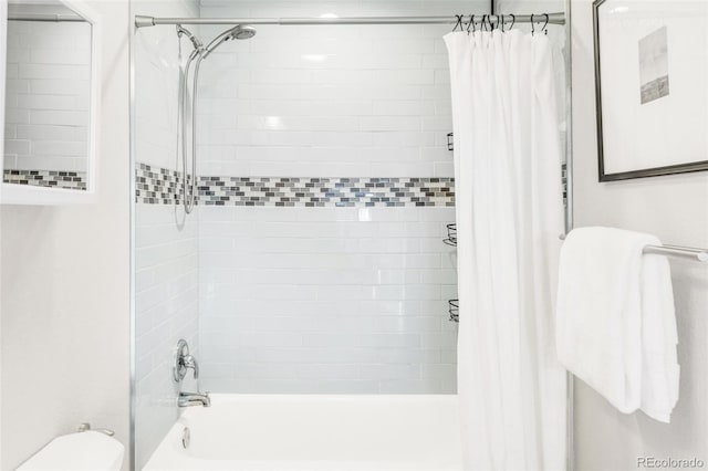 bathroom featuring toilet and shower / tub combo