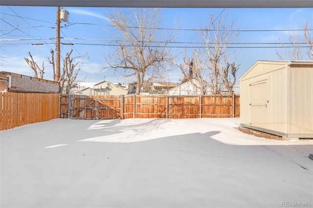 yard covered in snow with a shed