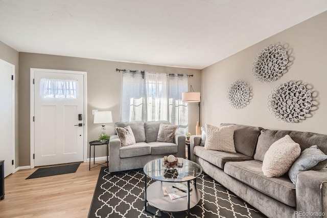 living area with light wood finished floors and baseboards