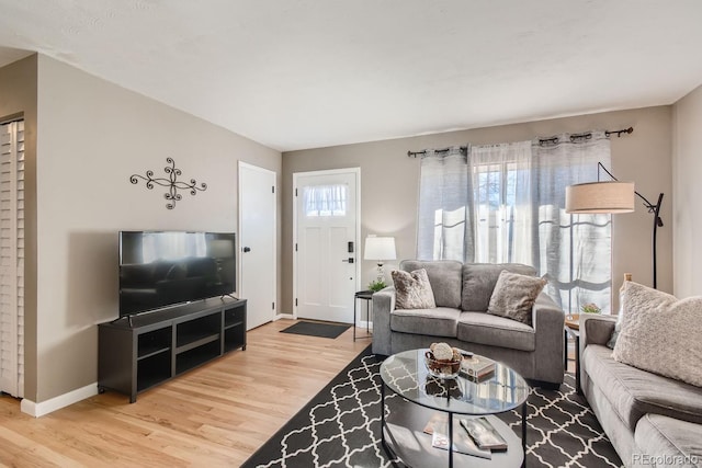 living area with wood finished floors and baseboards