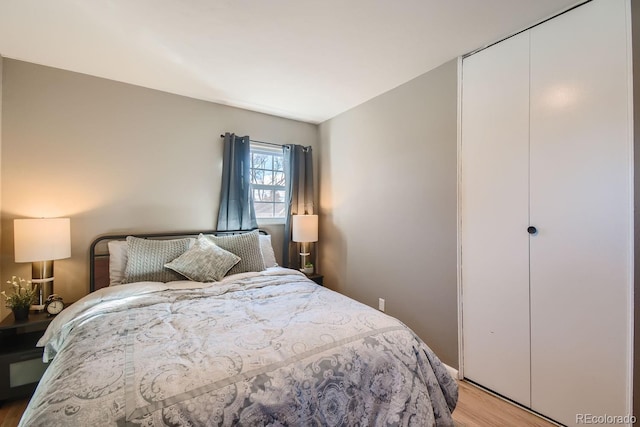 bedroom featuring a closet and light wood-type flooring