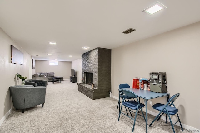 living area with carpet floors, a brick fireplace, visible vents, and baseboards