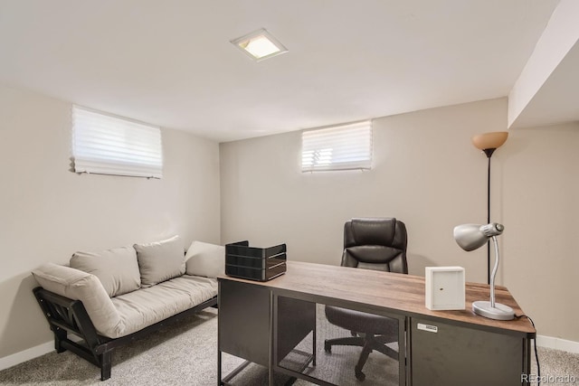 carpeted office space featuring baseboards