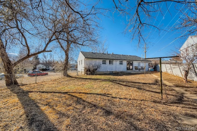 back of property featuring a patio area, a fenced backyard, and a lawn