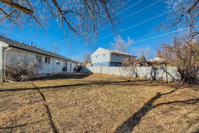 view of yard with a fenced backyard