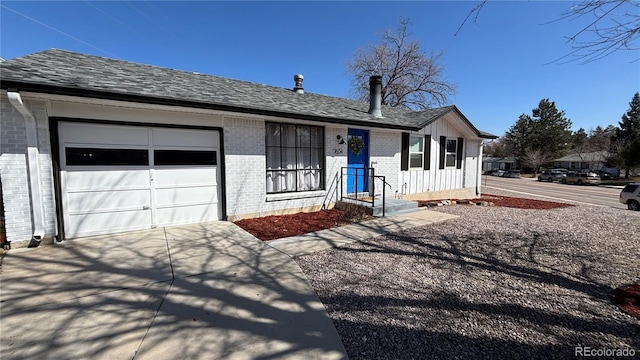 ranch-style home with an attached garage, brick siding, driveway, and a shingled roof