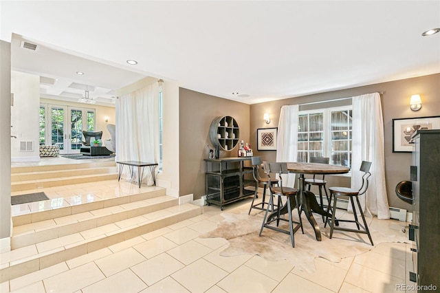 tiled dining room featuring french doors, beamed ceiling, coffered ceiling, and a baseboard heating unit