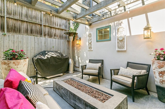 view of patio featuring a grill, a pergola, and an outdoor living space with a fire pit