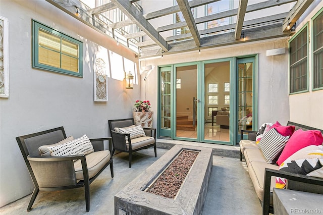 view of patio featuring a pergola and an outdoor living space with a fire pit