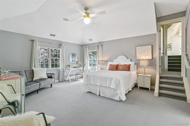 carpeted bedroom featuring lofted ceiling and ceiling fan