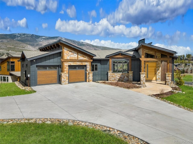 2800 Honors Ct, Silverthorne, CO 80498 - contemporary house featuring stone siding, driveway, an attached garage, a chimney, and a mountain view