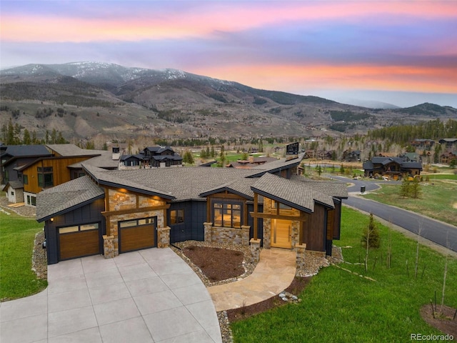 2800 Honors Ct, Silverthorne, CO 80498 - contemporary house with stone siding, concrete driveway, a shingled roof, and a mountain view