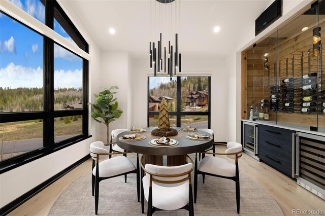 2800 Honors Ct, Silverthorne, CO 80498 - dining space with wine cooler, light wood-type flooring, a bar, and recessed lighting