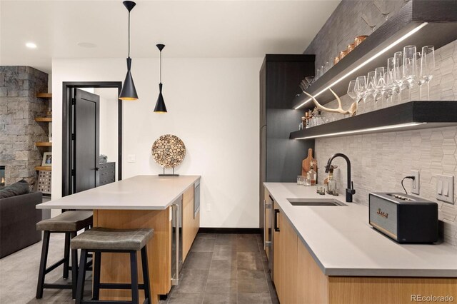 2800 Honors Ct, Silverthorne, CO 80498 - kitchen with a sink, open shelves, modern cabinets, a peninsula, and light countertops