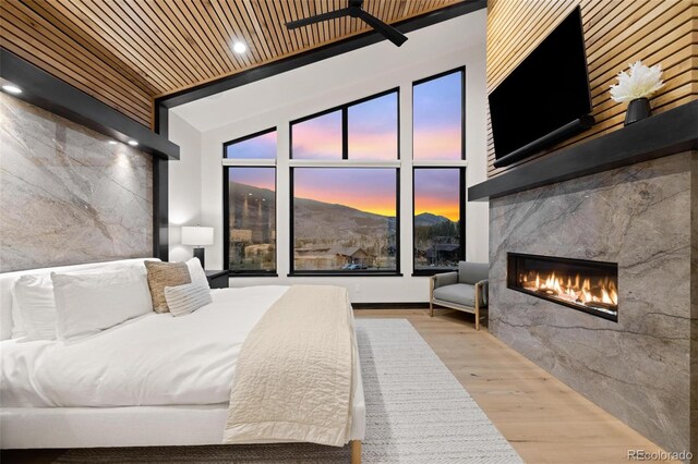 2800 Honors Ct, Silverthorne, CO 80498 - bedroom featuring a high end fireplace, wood finished floors, high vaulted ceiling, and wooden ceiling
