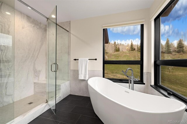 2800 Honors Ct, Silverthorne, CO 80498 - full bathroom with tile walls, a shower stall, a freestanding bath, tile patterned flooring, and recessed lighting