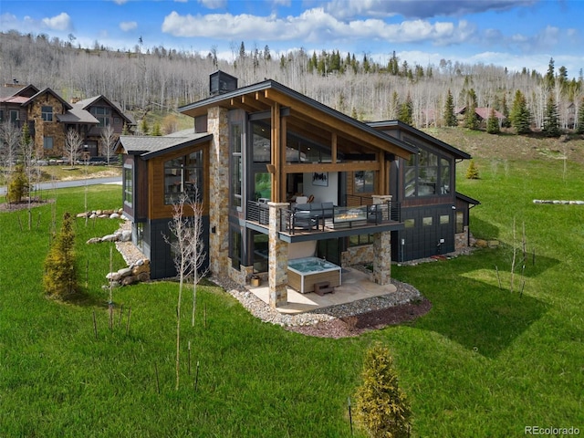 2800 Honors Ct, Silverthorne, CO 80498 - rear view of property with a sunroom, stone siding, a patio area, and a yard