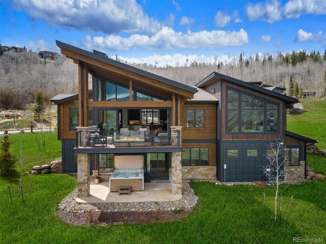 2800 Honors Ct, Silverthorne, CO 80498 - rear view of house featuring a yard, a hot tub, and stone siding
