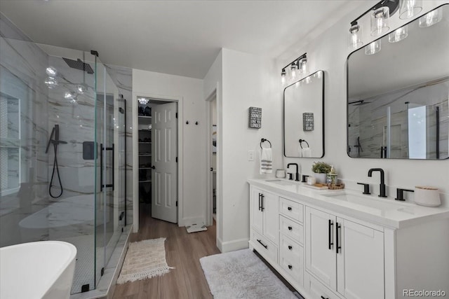 8051 W 78th Cir, Arvada, CO 80005 - bathroom featuring a marble finish shower, wood finished floors, double vanity, and a soaking tub