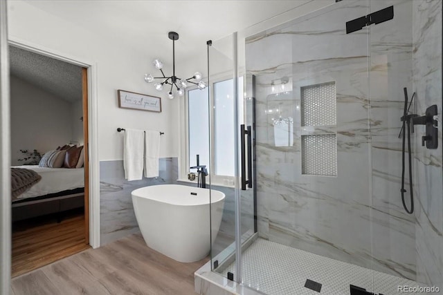 8051 W 78th Cir, Arvada, CO 80005 - full bath with connected bathroom, a marble finish shower, a chandelier, wood finished floors, and tile walls