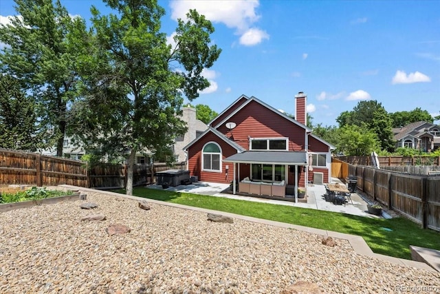 8051 W 78th Cir, Arvada, CO 80005 - back of property with a patio, a hot tub, a fenced backyard, and a chimney