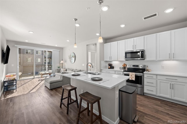 kitchen featuring white cabinetry, sink, stainless steel appliances, and dark hardwood / wood-style floors