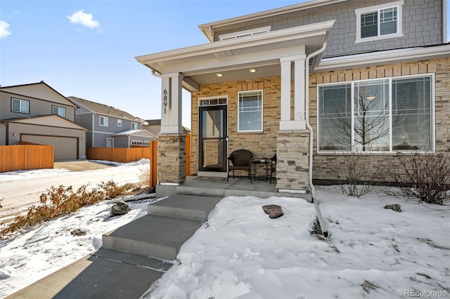 view of front of home featuring a porch and a garage