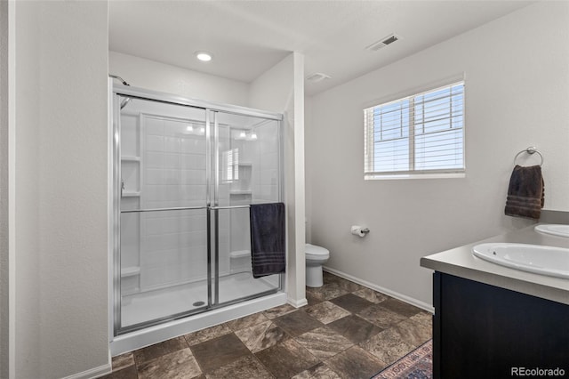 bathroom with vanity, toilet, and an enclosed shower