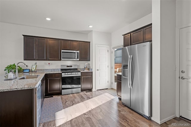 kitchen with dark brown cabinetry, sink, and appliances with stainless steel finishes