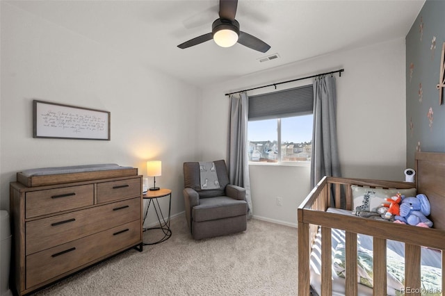 bedroom featuring light colored carpet and ceiling fan