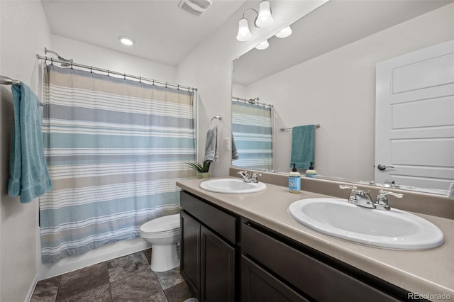 bathroom with walk in shower, vanity, and toilet