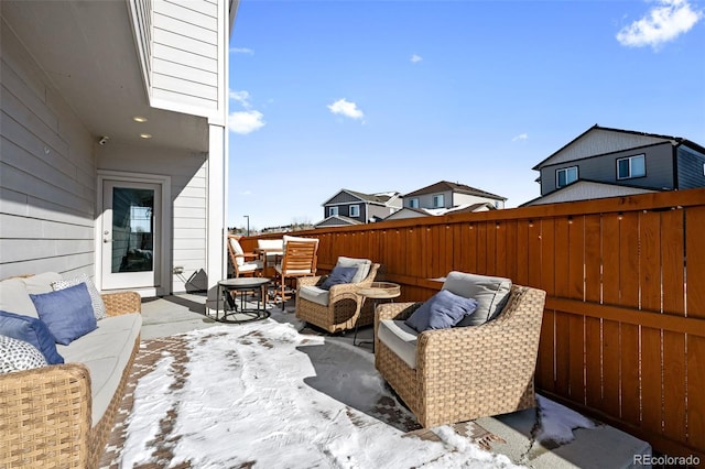 snow covered patio featuring an outdoor living space