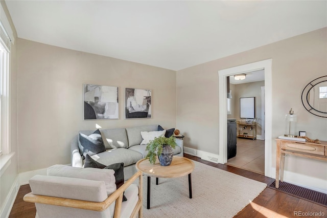 living room with baseboards and wood finished floors