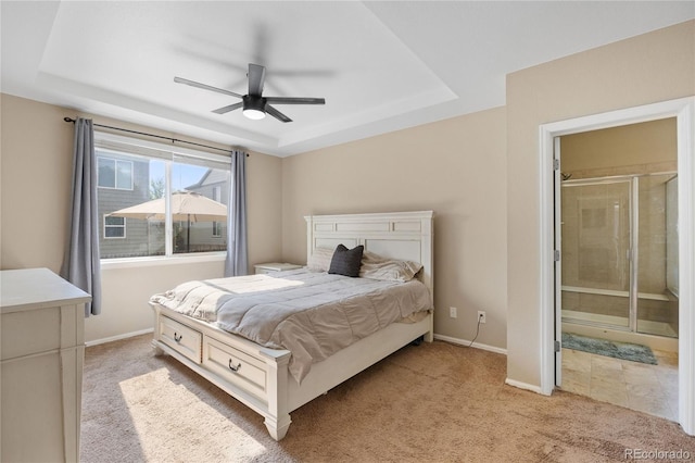 41 Jordan Ln, Erie, CO 80516 - bedroom with a tray ceiling, light colored carpet, baseboards, ensuite bath, and a ceiling fan
