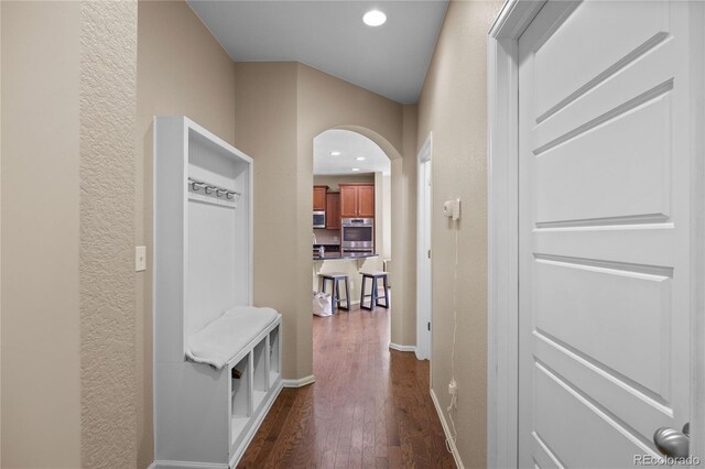 41 Jordan Ln, Erie, CO 80516 - mudroom with arched walkways, dark wood finished floors, a textured wall, recessed lighting, and baseboards