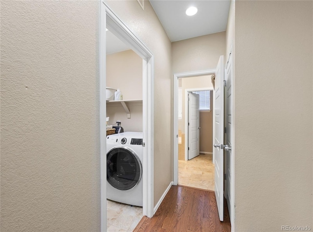 41 Jordan Ln, Erie, CO 80516 - clothes washing area with washer / dryer, wood finished floors, and a textured wall