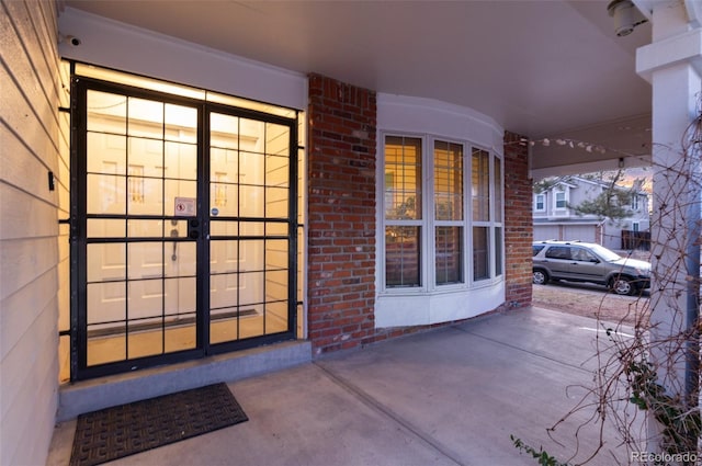 view of exterior entry with brick siding