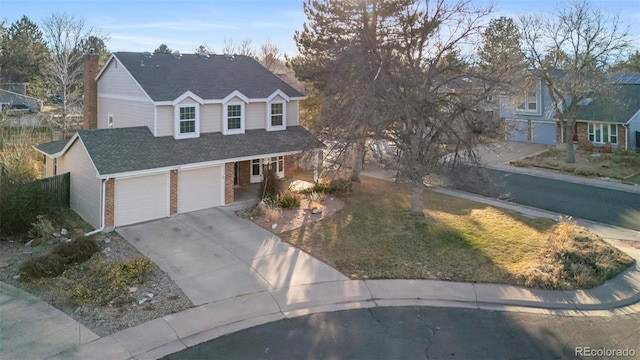 traditional-style home featuring brick siding, concrete driveway, a garage, and a shingled roof