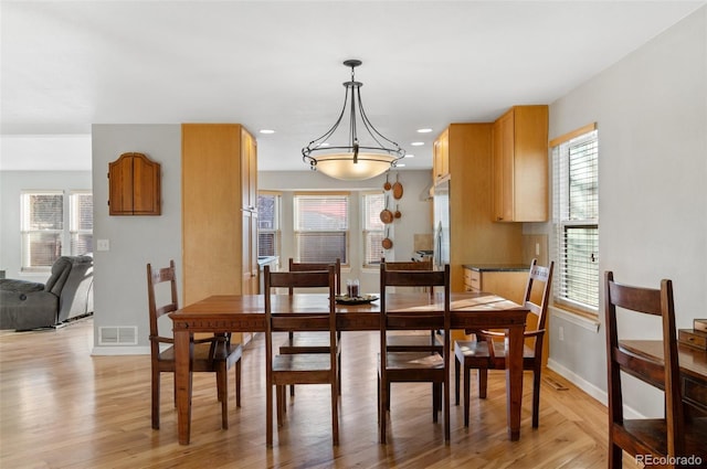 dining room featuring recessed lighting, baseboards, visible vents, and light wood-type flooring