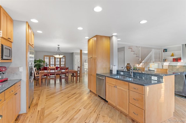 kitchen featuring light wood-style flooring, a sink, recessed lighting, stainless steel appliances, and a peninsula