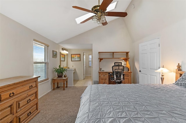 carpeted bedroom featuring high vaulted ceiling, a skylight, baseboards, and a ceiling fan