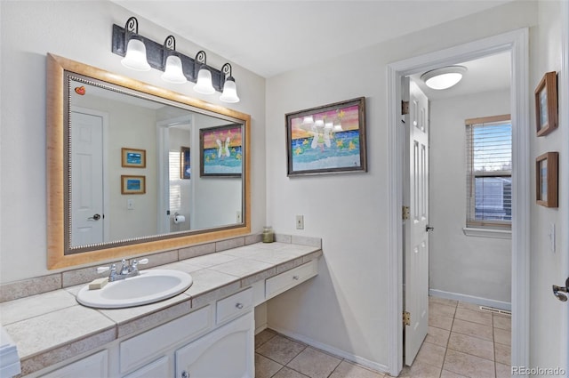 bathroom featuring tile patterned floors, baseboards, and vanity