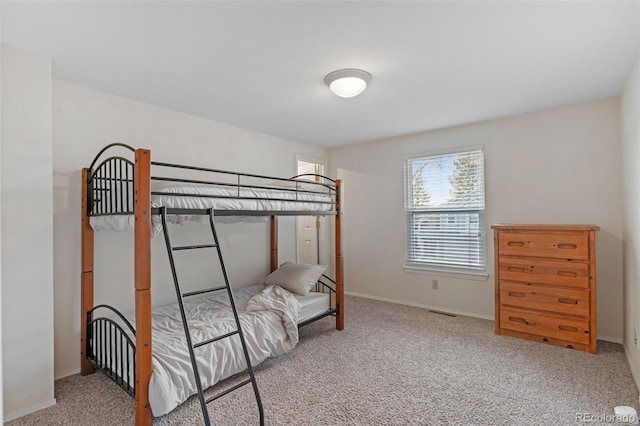 bedroom with visible vents, baseboards, and carpet