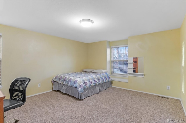 carpeted bedroom featuring visible vents and baseboards