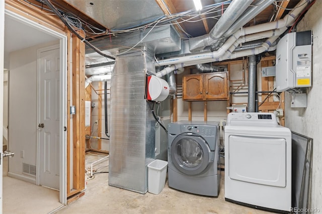 unfinished basement featuring visible vents and washing machine and clothes dryer