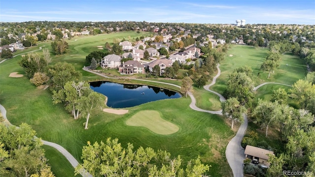 birds eye view of property with a water view and golf course view