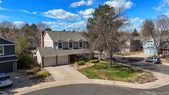 10200 Julian St, Westminster, CO 80031 - traditional home featuring a garage, brick siding, roof with shingles, and concrete driveway