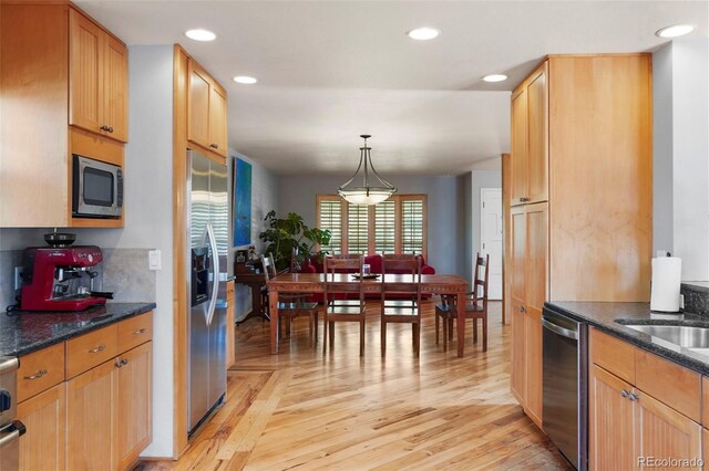 10200 Julian St, Westminster, CO 80031 - kitchen featuring light wood finished floors, decorative light fixtures, recessed lighting, and appliances with stainless steel finishes