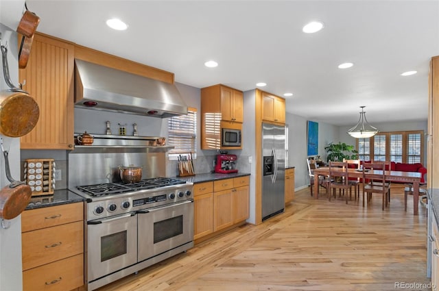 10200 Julian St, Westminster, CO 80031 - kitchen with wall chimney exhaust hood, light wood-style flooring, dark countertops, decorative backsplash, and appliances with stainless steel finishes